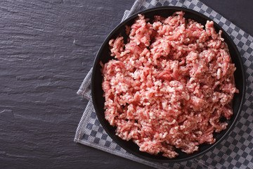Raw minced pork in a plate horizontal  top view 
