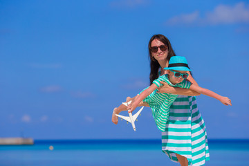 Little girl and young mother during beach vacation