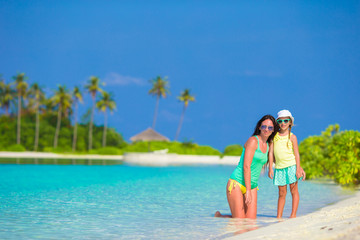 Little girl and young mother during beach vacation