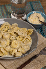 Tortellini with Basil Cream Sauce. Selective focus.