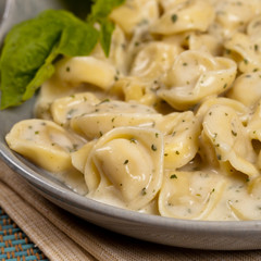 Tortellini with Basil Cream Sauce. Selective focus.
