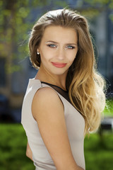 Portrait close up of young beautiful blonde woman, on background