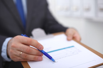 Businessman holding a blank white board
