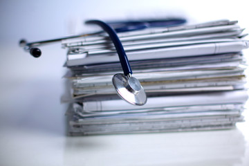Medical stethoscope on the stack of paper
