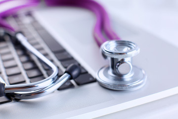 Violet stethoscope on a laptop computer