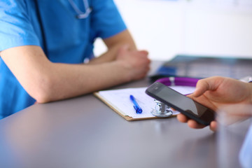 Doctor and patient sitting on the desk