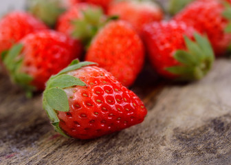Fresh strawberries on old wooden background
