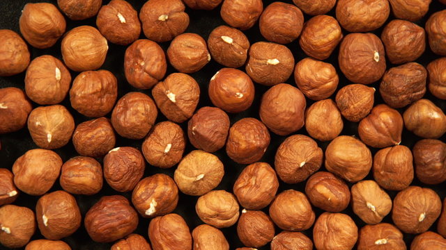 Peeled hazelnut kernels is circling
