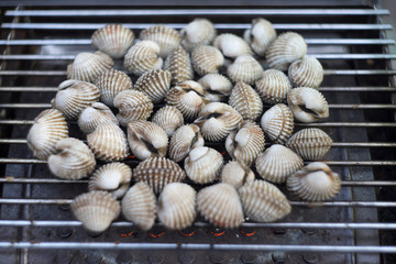 Cockles on flaming grill