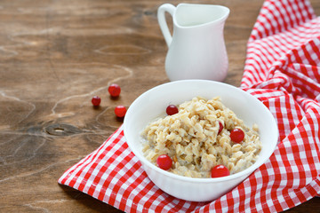 oatmeal with berries and milk on the boards