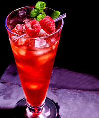 Red cocktail  and mint on dark background.