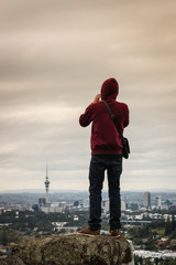 tourist taking picture of Auckland skyline