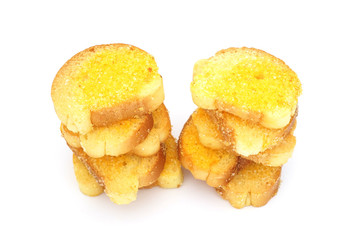 crispy baked bread with butter and sugar on white background