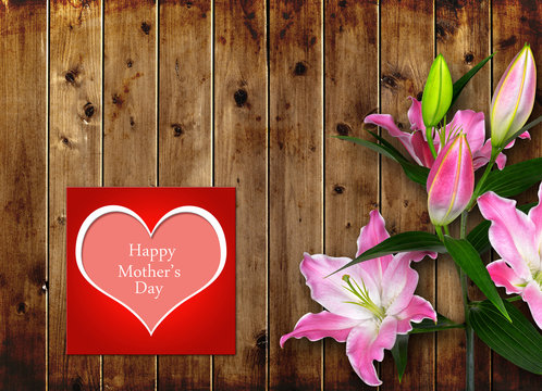 Mothers day card with pink Lily flower on wooden board