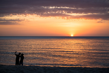 Fototapeta premium Couple shooting on the beach