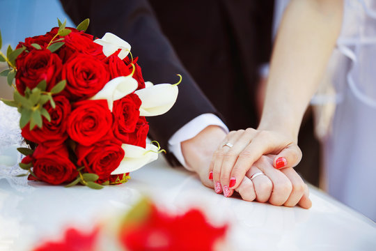 Picture of man and woman hands with wedding ring holding tender