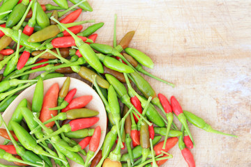 Red green and brown Chili on wood background