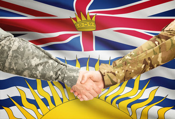 Military handshake and Canadian province flag - British Columbia © niyazz
