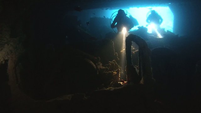 Diver inspects the cargo in the hold of the wreck Thistlegorm 