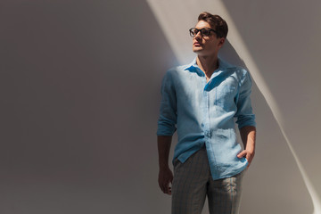 Attractive young casual man looking up