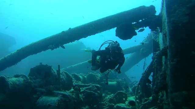diver inspects the winch mechanism on shipwreck 