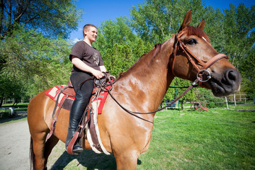 Obraz premium happy teenager boy on the horse