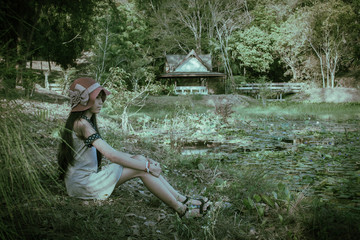 vintage of child girl sitting at the swamp