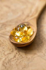 Fish oil capsules in a spoon