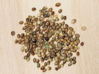 Hemp seeds close up isolation on wood background