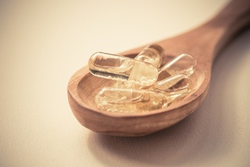 Fish oil capsules in a spoon