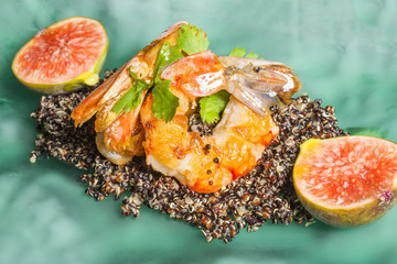 Shrimps served with black quinoa and fig