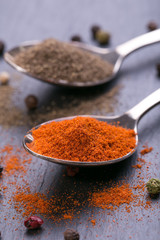 Sliced, dried, red chili peppers and seeds on a stones background