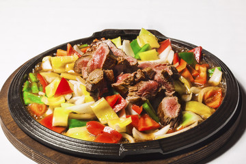 Vegetables and beef on iron hot plate