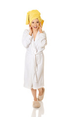 Young smiling woman in bathrobe
