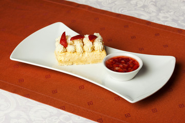 Strawberry cake with strawberry sauce served on the side