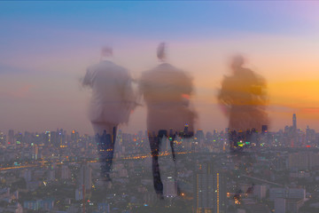 motion blur business people with twilight cityscape background