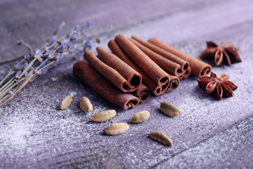 Spices with lavender and powdered sugar on color wooden table background