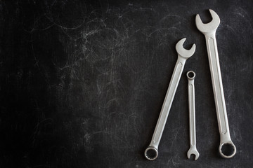 Set of 3 Wrenches on a Dark Textured Background