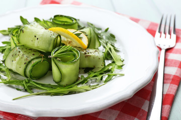 Plate of green salad with cucumber, arugula and rosemary, closeup © Africa Studio
