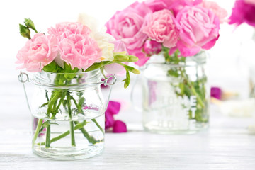 Beautiful spring flowers in glass bottles