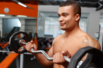 Portrait of weightlifter with barbell in his hands