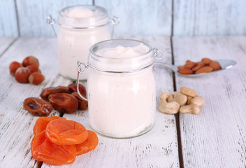 Healthy breakfast with dried fruits and nuts on color wooden background