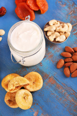 Healthy breakfast with dried fruits and nuts on color wooden background
