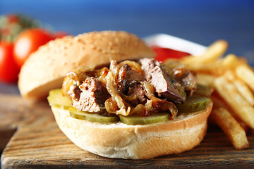 Tasty burger and french fries on wooden table background , close-up Unhealthy food concept