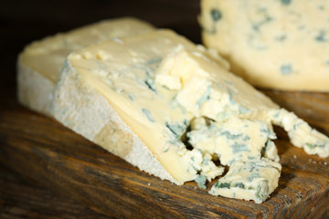 Blue cheese on wooden cutting board. closeup