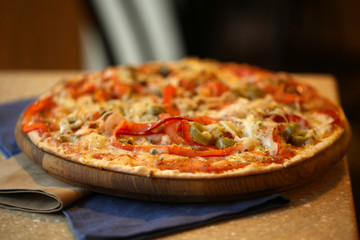 Delicious pizza on table in cafe