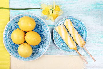 Lemons and ice cream on plates on table top view