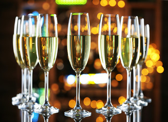 Glasses of champagne on bar background