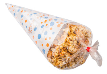 Caramel popcorn in a paper cone pack over white background