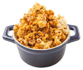 Caramel popcorn in blue pot over white background